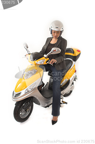 Image of woman riding scooter