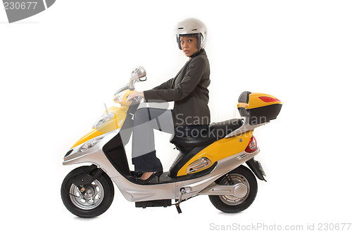 Image of woman riding scooter