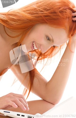 Image of happy redhead woman with laptop computer