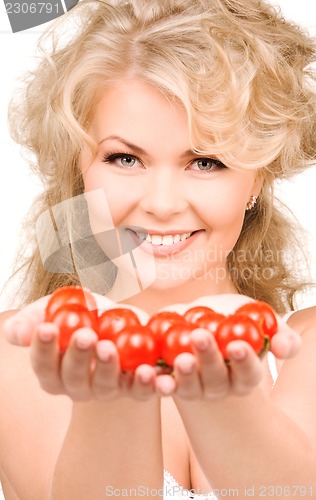 Image of young beautiful woman with ripe tomatoes
