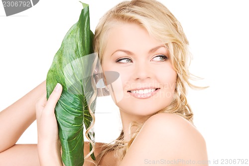 Image of woman with green leaf