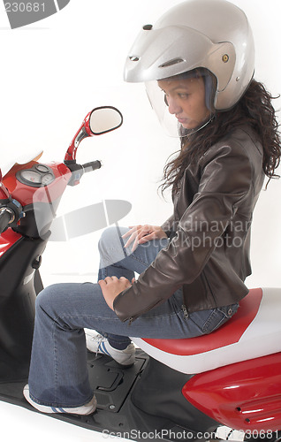 Image of woman riding scooter