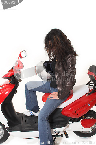 Image of woman riding electric scooter with no helmet