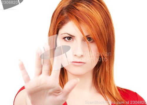 Image of woman showing stop sign