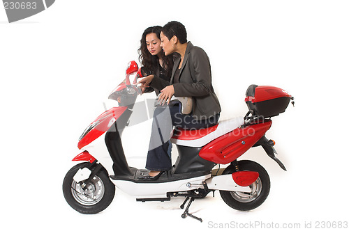 Image of couple girls talking on  scooter