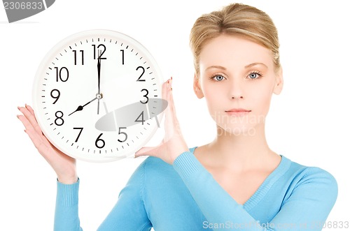 Image of woman holding big clock