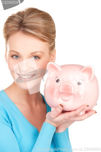 Image of lovely woman with piggy bank