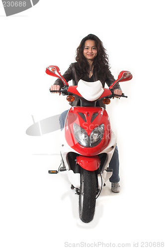 Image of woman riding electric scooter with no helmet