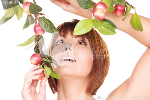 Image of happy woman with apple twig