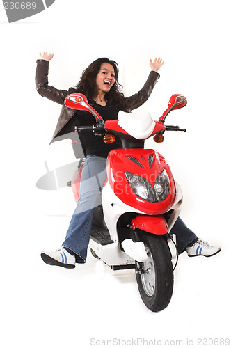 Image of woman riding electric scooter with no helmet