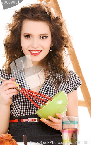 Image of young attractive woman in the kitchen