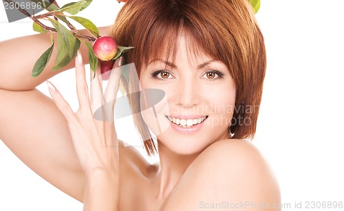 Image of happy woman with apple twig