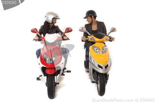 Image of couple girls talking on  scooter