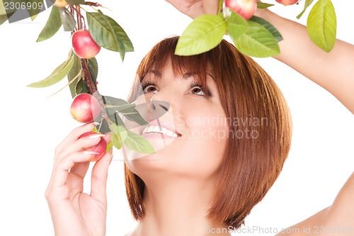 Image of happy woman with apple twig