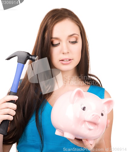 Image of teenage girl with piggy bank and hammer