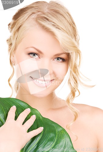 Image of woman with green leaf