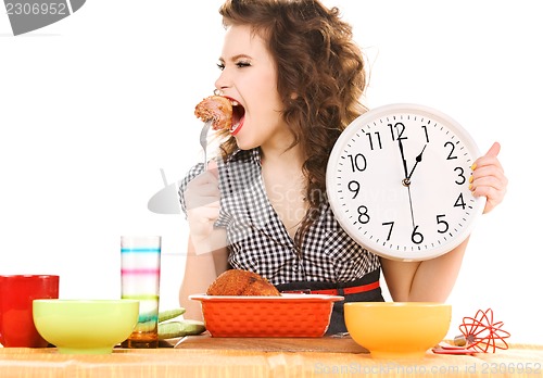 Image of young attractive woman in the kitchen