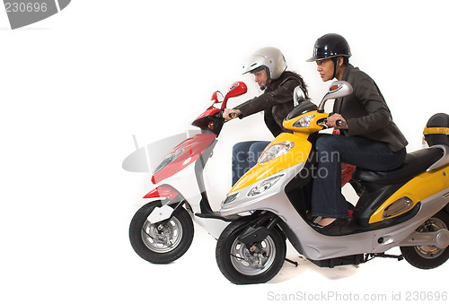 Image of couple girls racing on electric scooter