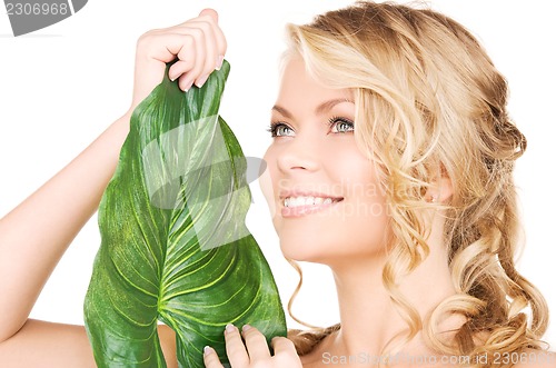 Image of woman with green leaf