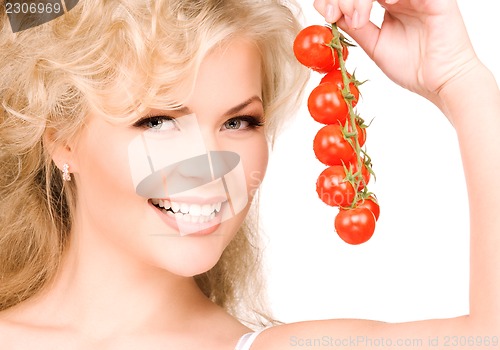 Image of young beautiful woman with ripe tomatoes