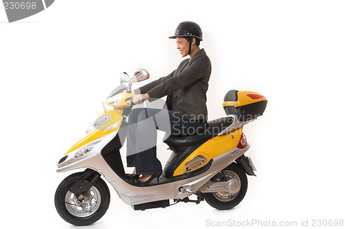 Image of woman riding scooter