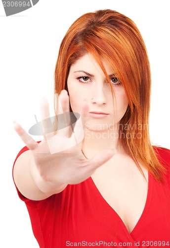 Image of woman showing stop sign