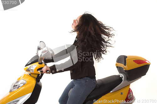 Image of woman riding electric scooter with no helmet