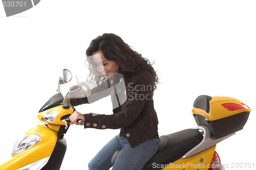 Image of woman riding electric scooter with no helmet
