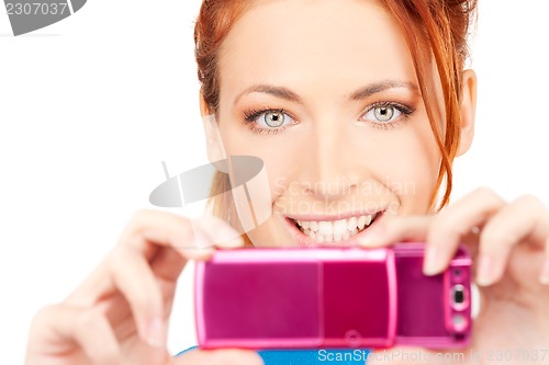 Image of happy woman using phone camera