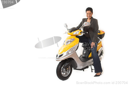 Image of woman riding electric scooter with no helmet