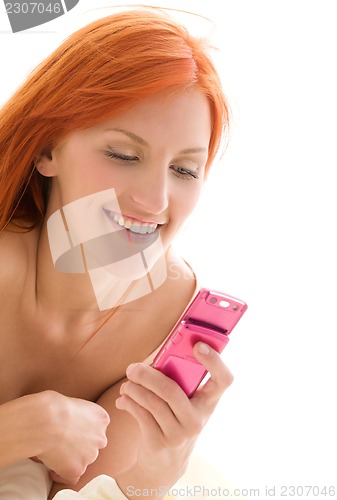 Image of happy redhead woman with cell phone