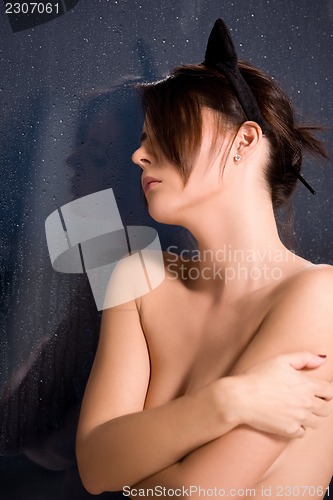 Image of woman with cat ears at the rainy window