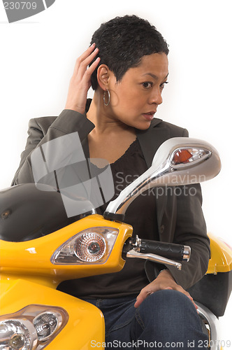 Image of woman riding electric scooter with no helmet