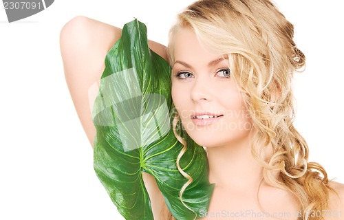 Image of woman with green leaf