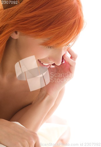 Image of happy redhead woman with cell phone