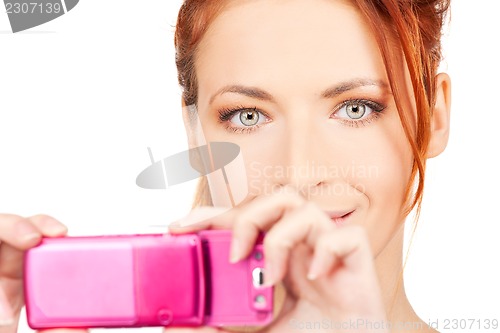 Image of happy woman using phone camera