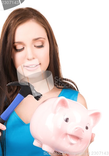 Image of teenage girl with piggy bank and hammer