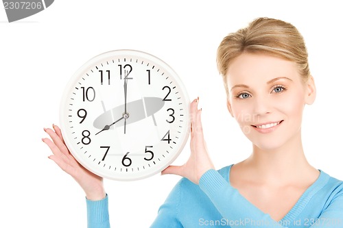 Image of woman holding big clock