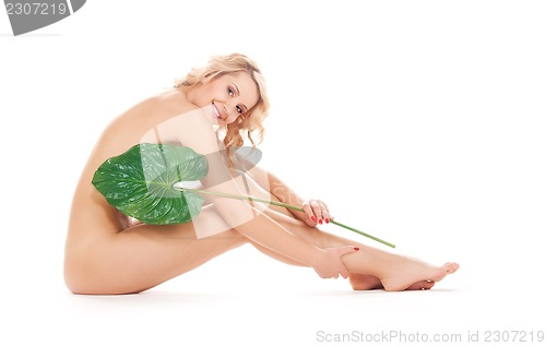 Image of woman with green leaf over white