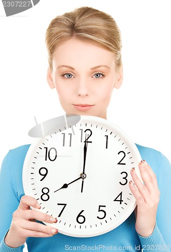 Image of woman holding big clock