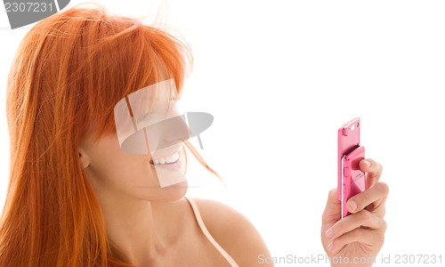 Image of happy redhead woman with cell phone