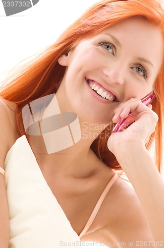 Image of happy redhead woman with cell phone