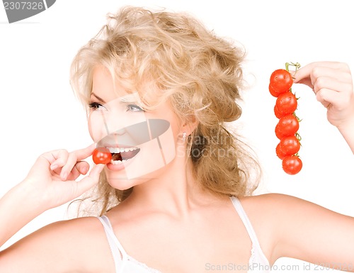 Image of young beautiful woman with ripe tomatoes