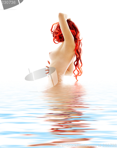Image of topless redhead in blue water