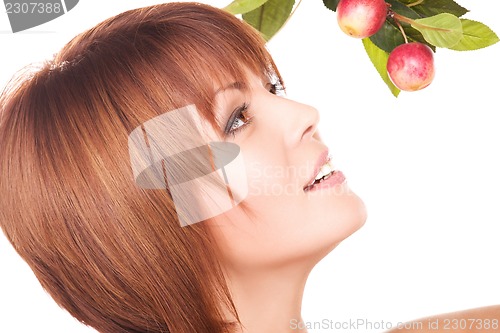 Image of happy woman with apple twig