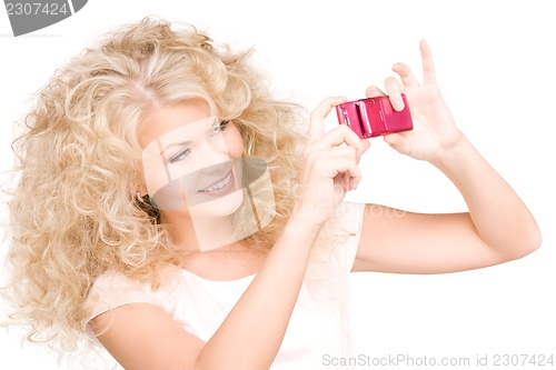 Image of happy woman using phone camera