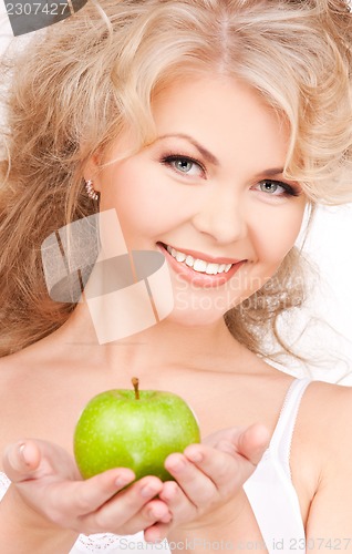 Image of young beautiful woman with green apple