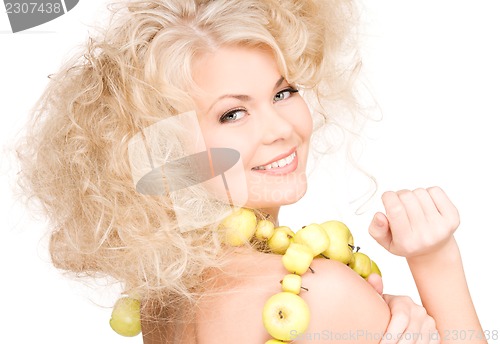 Image of happy woman with green apples