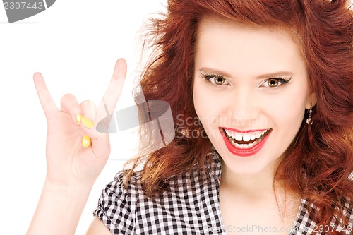Image of happy teenage girl showing devil horns gesture