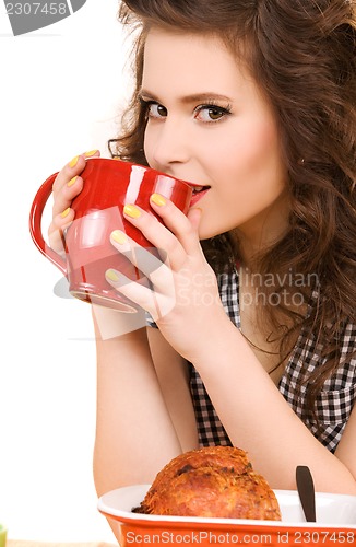 Image of young attractive woman in the kitchen